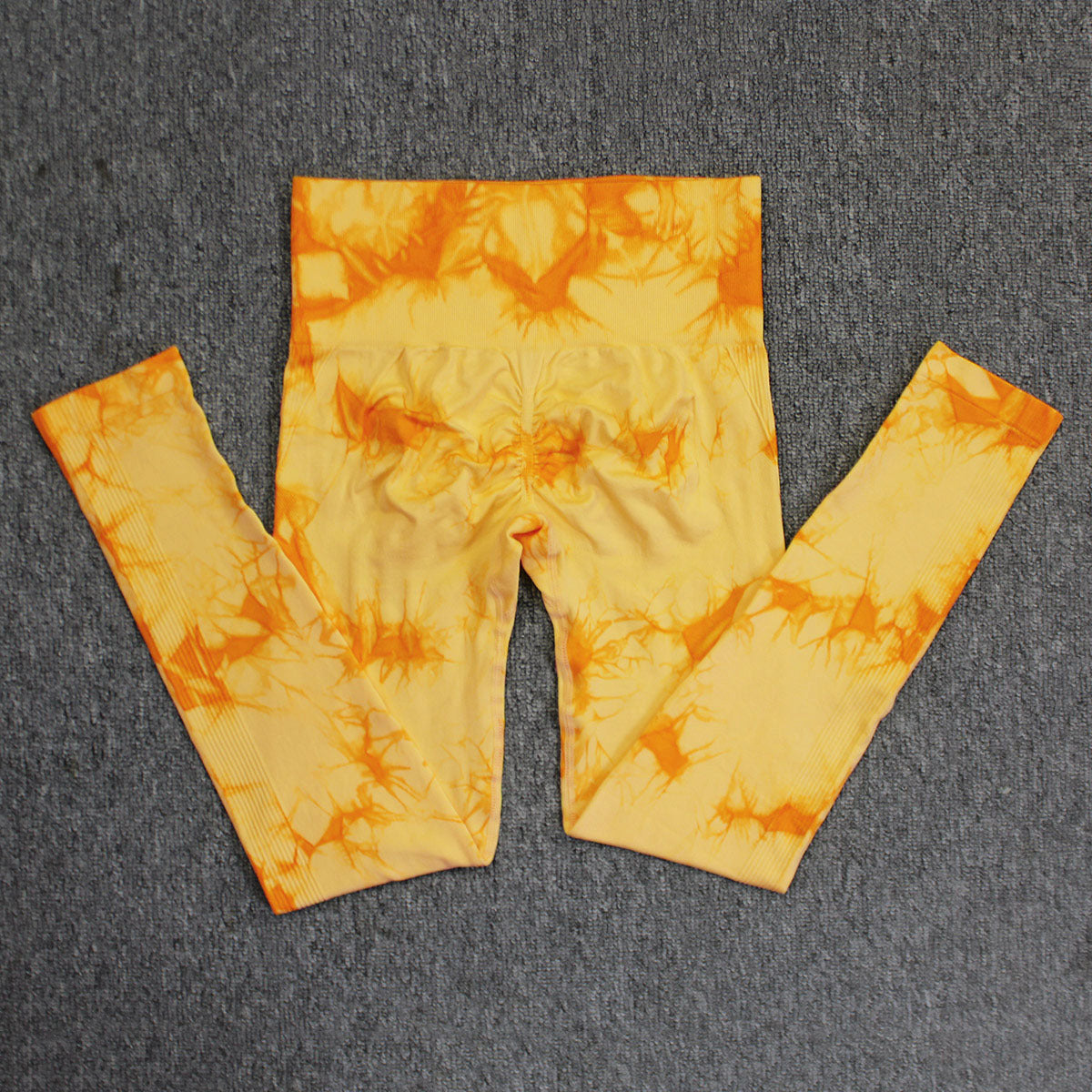 Vibrant seamless tie-dye yoga pants with high waist and peach hip lifting design. High-elastic compression leggings perfect for yoga and fitness.