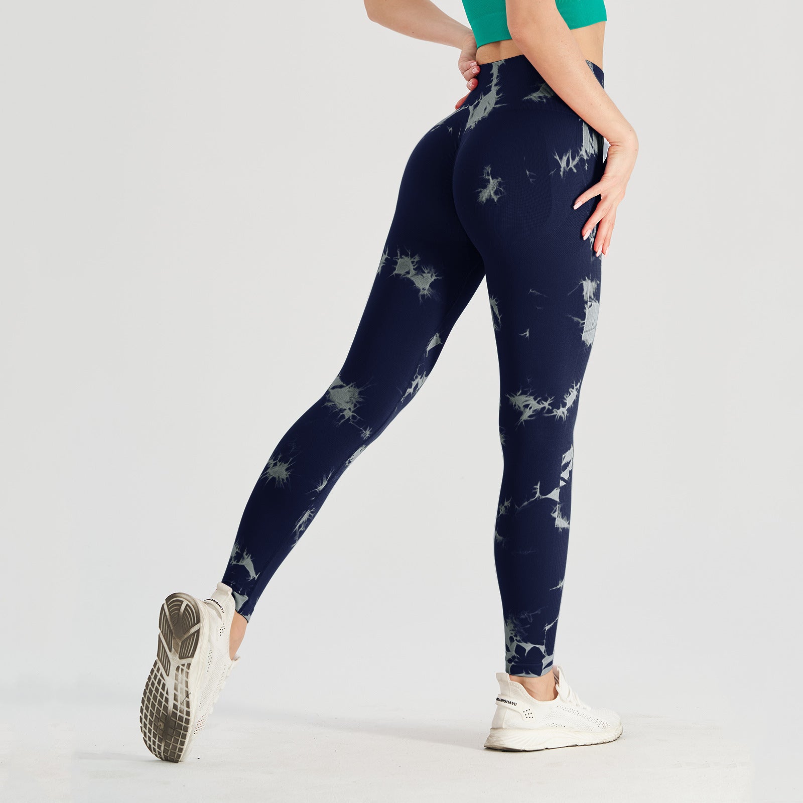 Vibrant seamless tie-dye yoga pants with high waist and peach hip lifting design. High-elastic compression leggings perfect for yoga and fitness.