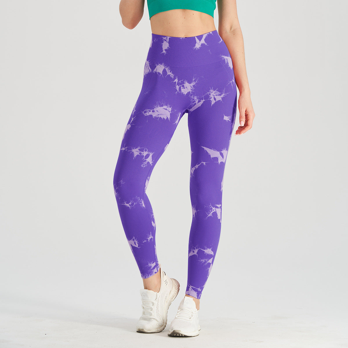 Vibrant seamless tie-dye yoga pants with high waist and peach hip lifting design. High-elastic compression leggings perfect for yoga and fitness.
