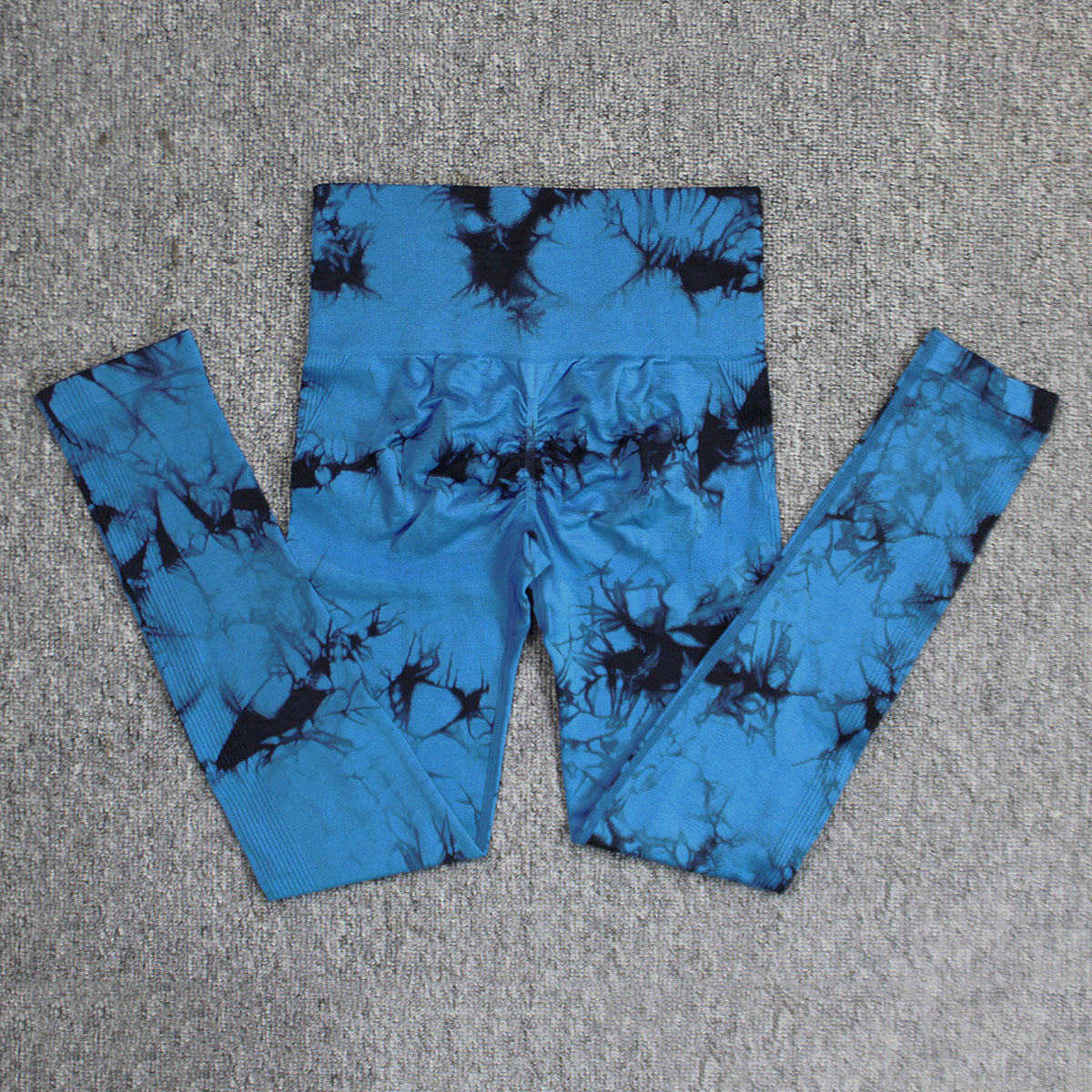 Vibrant seamless tie-dye yoga pants with high waist and peach hip lifting design. High-elastic compression leggings perfect for yoga and fitness.