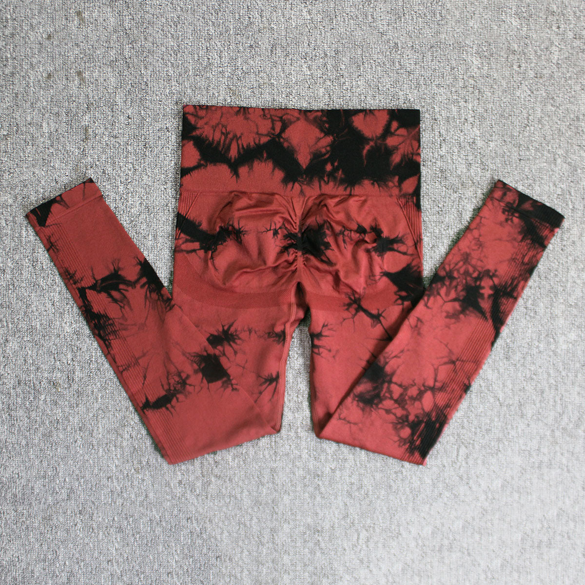 Vibrant seamless tie-dye yoga pants with high waist and peach hip lifting design. High-elastic compression leggings perfect for yoga and fitness.