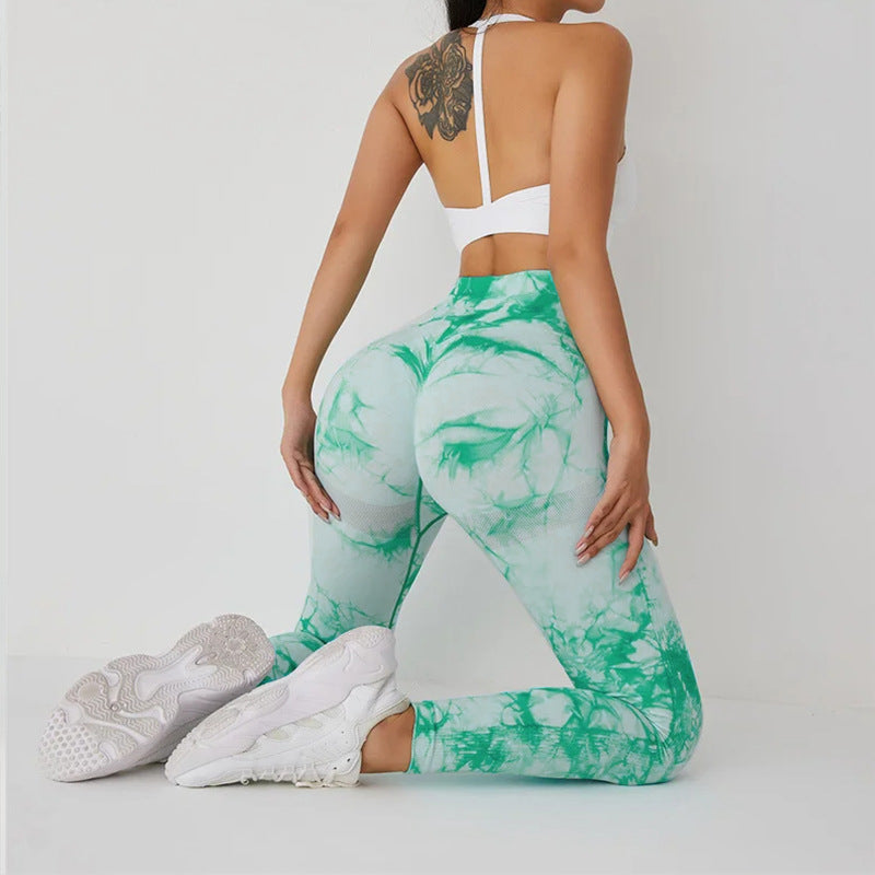 Vibrant seamless tie-dye yoga pants with high waist and peach hip lifting design. High-elastic compression leggings perfect for yoga and fitness.