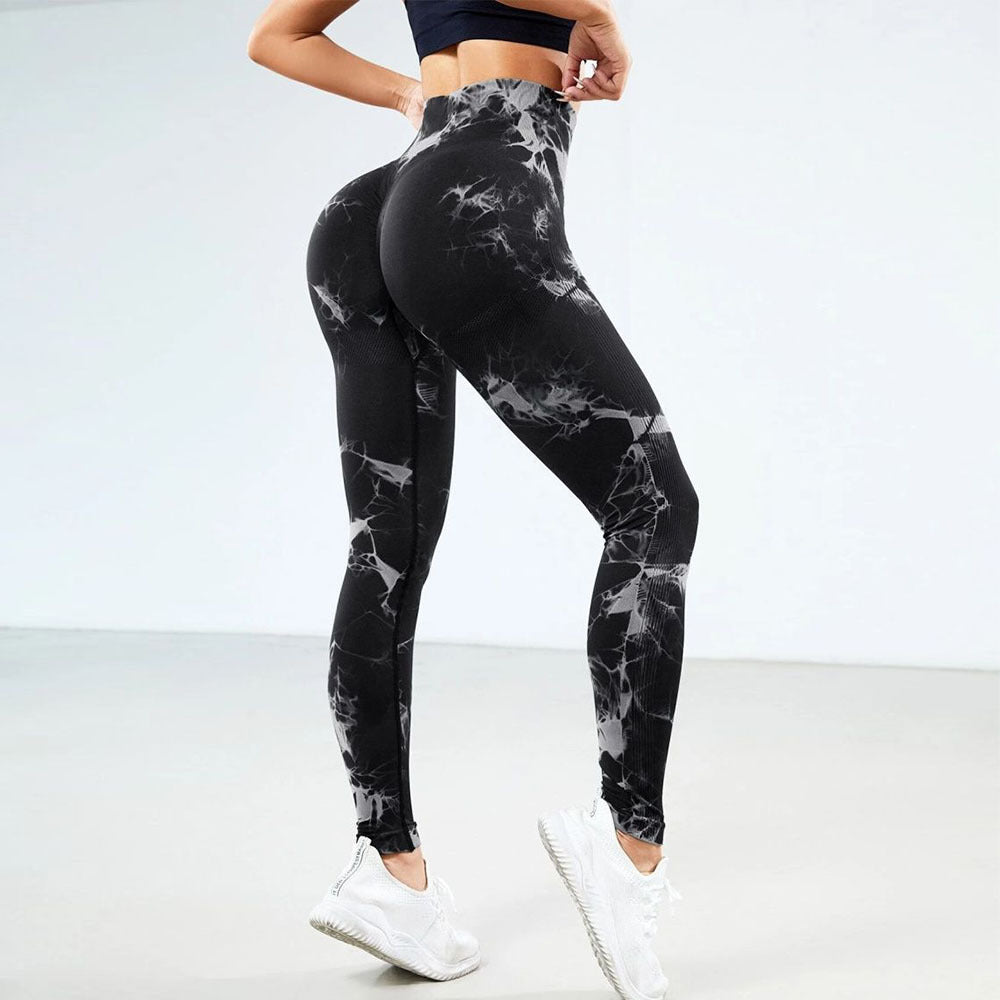 Vibrant seamless tie-dye yoga pants with high waist and peach hip lifting design. High-elastic compression leggings perfect for yoga and fitness.