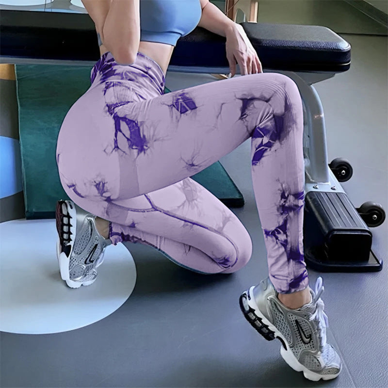 Vibrant seamless tie-dye yoga pants with high waist and peach hip lifting design. High-elastic compression leggings perfect for yoga and fitness.