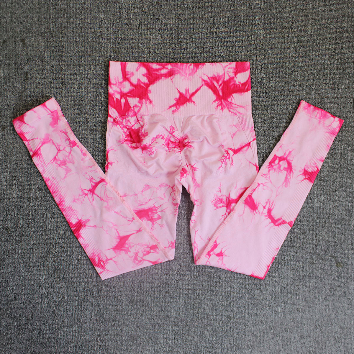Vibrant seamless tie-dye yoga pants with high waist and peach hip lifting design. High-elastic compression leggings perfect for yoga and fitness.
