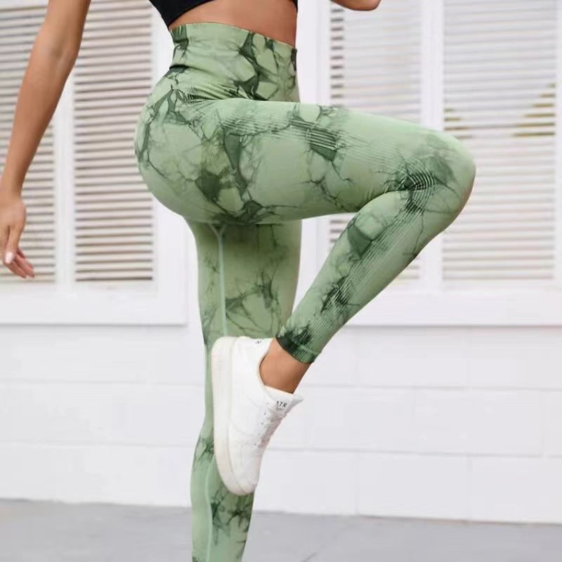 Vibrant seamless tie-dye yoga pants with high waist and peach hip lifting design. High-elastic compression leggings perfect for yoga and fitness.