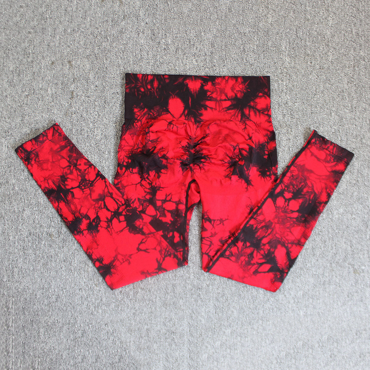 Vibrant seamless tie-dye yoga pants with high waist and peach hip lifting design. High-elastic compression leggings perfect for yoga and fitness.