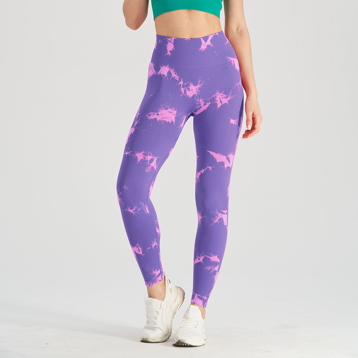 Vibrant seamless tie-dye yoga pants with high waist and peach hip lifting design. High-elastic compression leggings perfect for yoga and fitness.